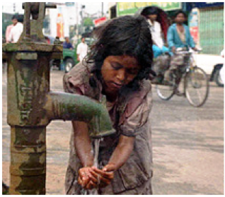 Photo of a girl in India getting water at a manual pump